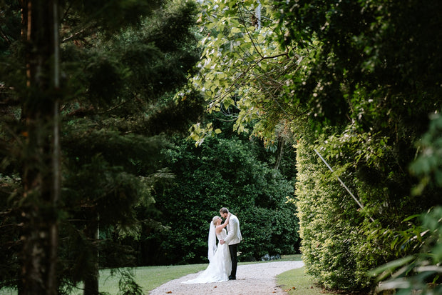 Beautiful shot of newlywed couple on the pathway to the hinterland venue.