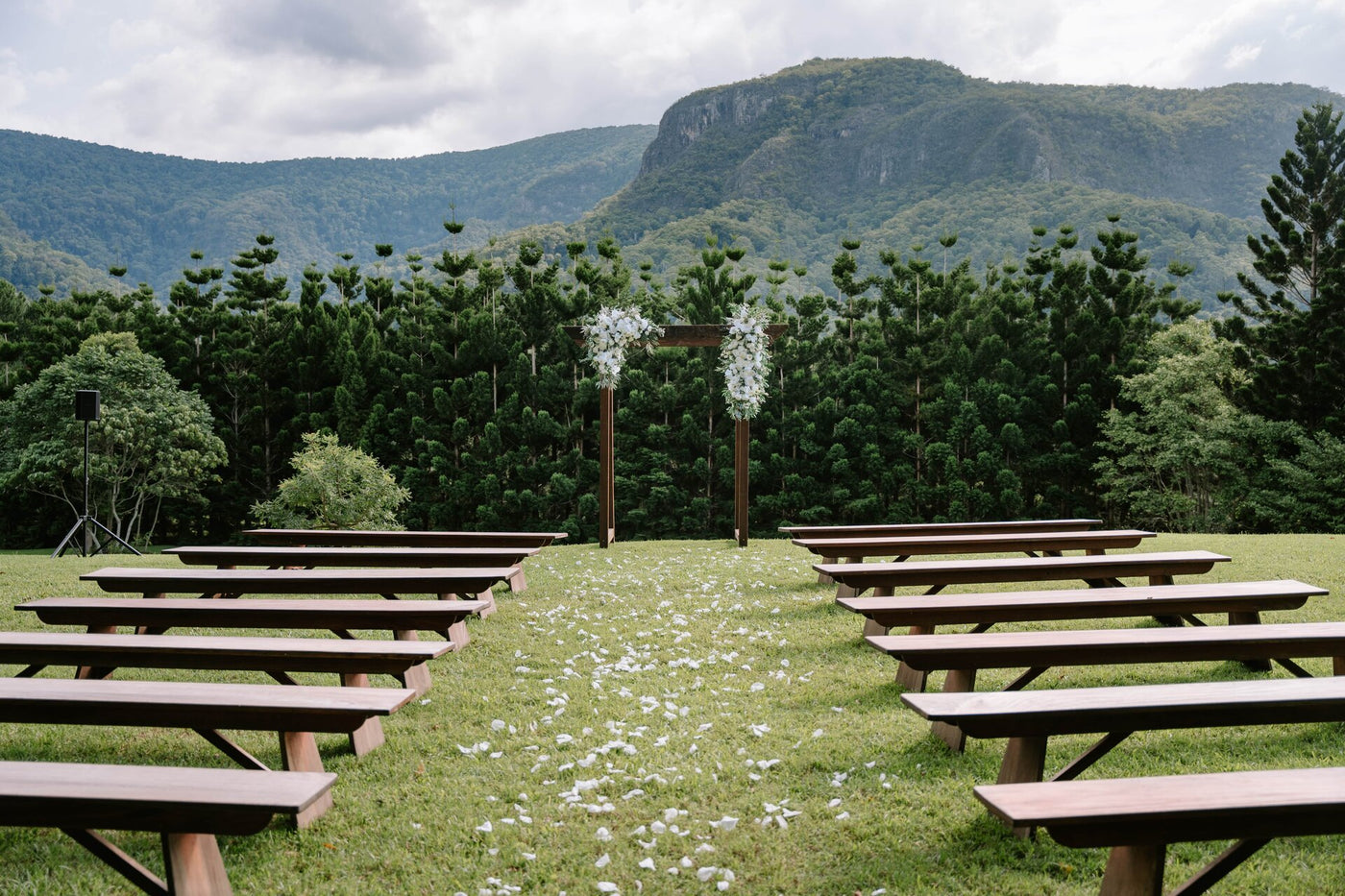 Wedding venue set up in a highland location with a breathtaking view of trees and mountains.