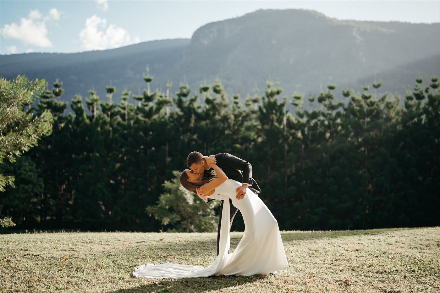 Newlywed couple kissing in a scenic mountain view wedding venue